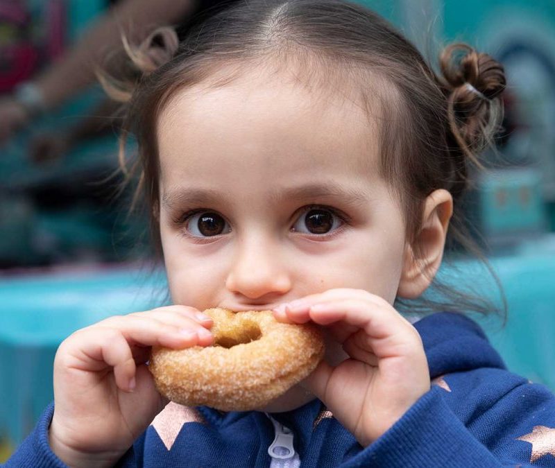 Little Girl Enjoying OMG! Decadent Donuts
